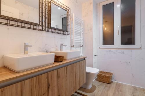 a bathroom with a sink and a toilet and a mirror at Old bilbao Con Vistas a la Ria by Urban Hosts in Bilbao