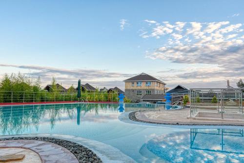 a large swimming pool with a building in the background at Aberdare Prestige & Royal Cottages in Nanyuki
