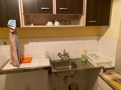 a kitchen counter with a sink in a kitchen at Апартамент in Varna City