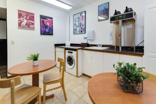a kitchen with a table and a washing machine at Stratford Inn in Ashland
