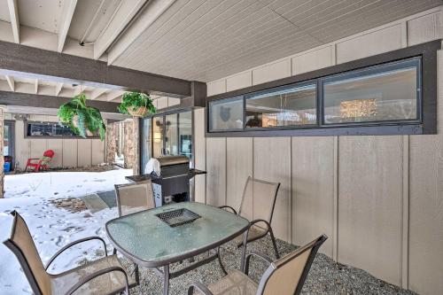 a patio with a table and chairs and a piano at Ski-InandSki-Out Condo with Hot Tub on Copper Mountain in Frisco