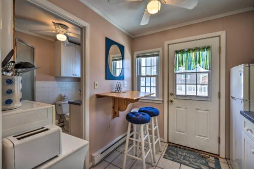 a kitchen with a counter and a stool in it at Cape Cod Retreat with Gas Grill Steps to Beach in Dennis Port