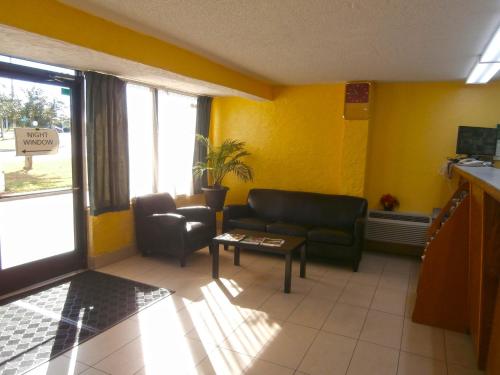 a living room with a couch and a table at Americas Best Value Inn Tucker in Tucker