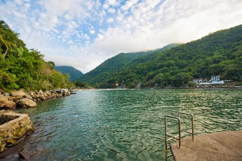 a body of water with mountains in the background at Villa Lala Boutique Hotel Adults Only in Puerto Vallarta