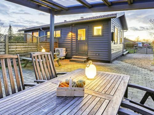 a picnic table in front of a tiny house at 4 person holiday home in Svendborg in Svendborg