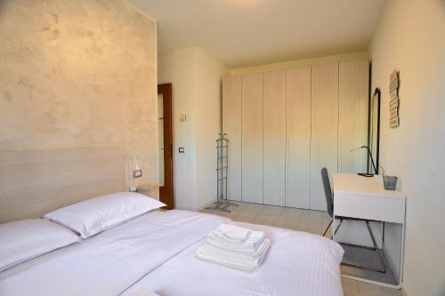 a bedroom with a bed and a desk and a table at Apartment Forum III in Assago