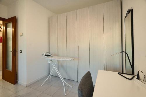 a room with a table and chairs and a wall at Apartment Forum III in Assago