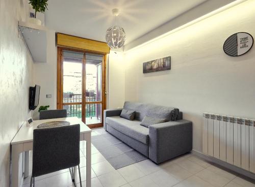 a living room with a couch and a table at Apartment Forum III in Assago