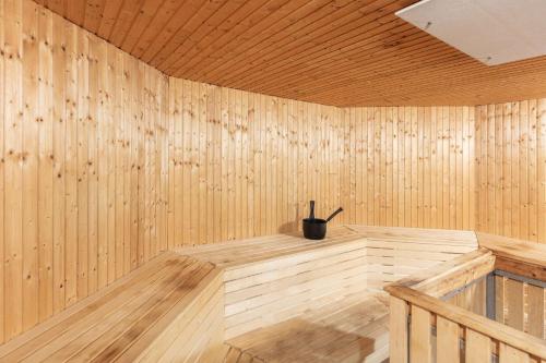 a wooden sauna with a black pot on top of it at Radisson Blu Hotel Malmö in Malmö