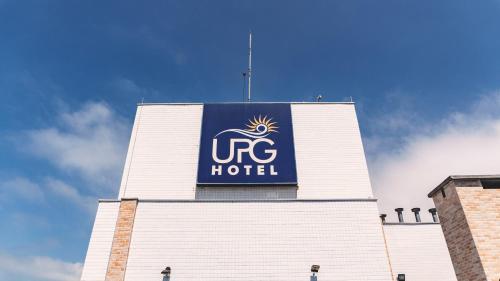 a hotel sign on the side of a building at UPG Hotel in Ubatuba