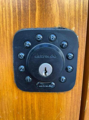 a black remote control on a wooden object at Casa Olié in Oaxaca City