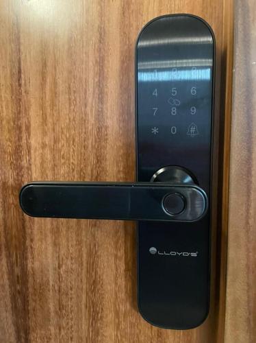 a black door handle on a wooden door at Casa Olié in Oaxaca City