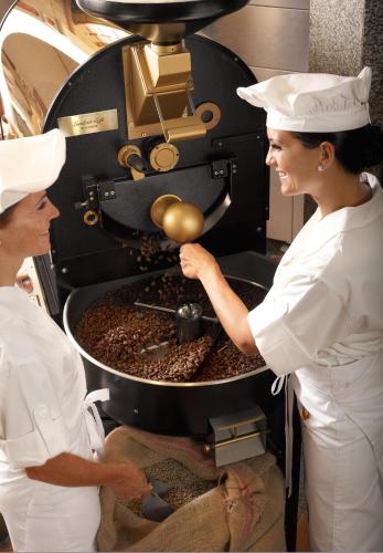 two women in a kitchen preparing food at Landzeit Restaurant Voralpenkreuz in Sattledt