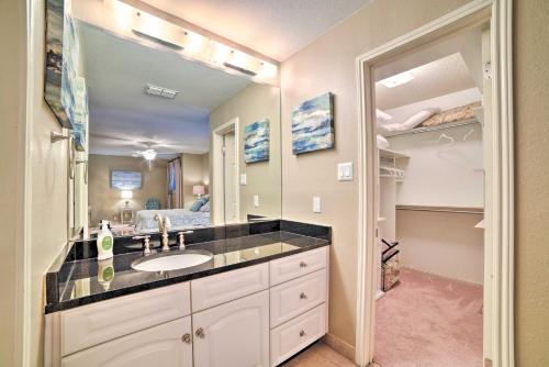 a bathroom with a sink and a large mirror at Bright and Breezy Condo, 2 Mi to Whitecap Beach! in Corpus Christi