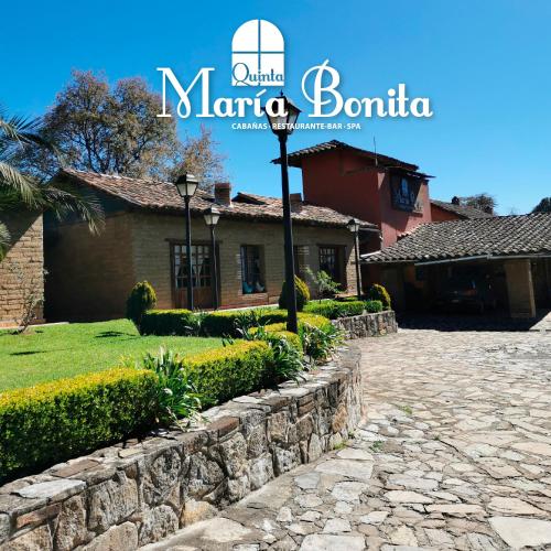 a house with a stone path in front of a building at Quinta Maria Bonita in Zacatlán