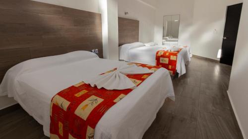 Postel nebo postele na pokoji v ubytování Hotel Galería del Ángel