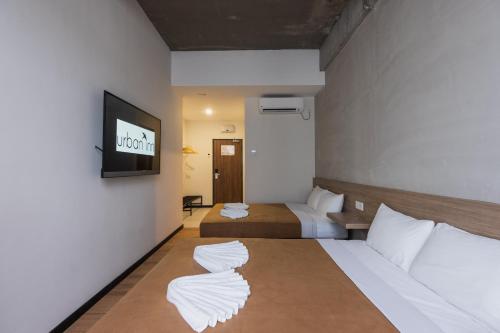 Кровать или кровати в номере Urban Inn, SP Saujana