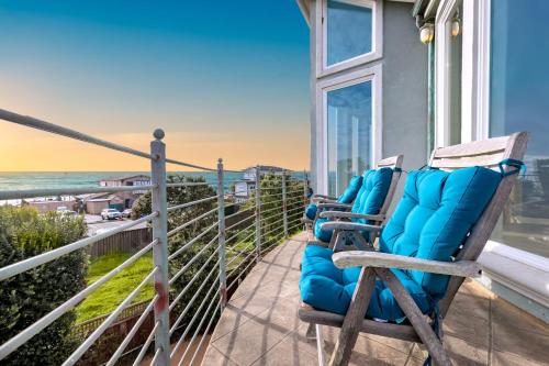 two chairs sitting on a balcony overlooking the ocean at Oceanview Miramar Home Steps to Beach Restaurants Trails Activities in Half Moon Bay