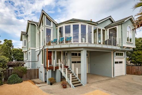 a house with a deck and a balcony at Oceanview Miramar Home Steps to Beach Restaurants Trails Activities in Half Moon Bay