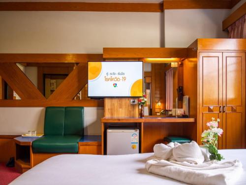 a hotel room with a bed and a television at โรงแรมศิริโฮเต็ล Sirihotel Korat in Nakhon Ratchasima