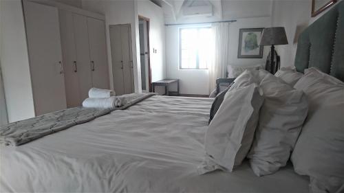 a large white bed in a white bedroom at St Lucia Eco Lodge in St Lucia