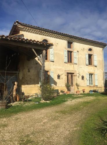 a large stone building with a bench in front of it at La Maison de Louis in Francon