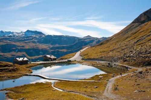 a view of a mountain with a road and a lake at Hotel Forsthof in Sankt Johann im Pongau