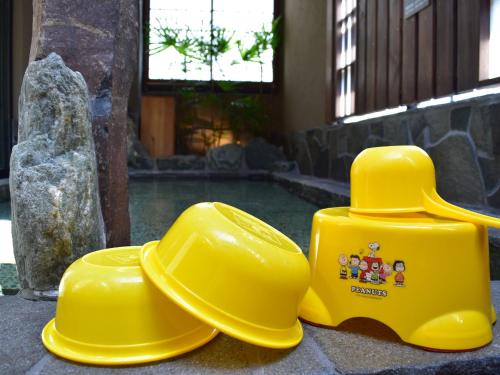 two yellow rubber hats sitting next to a pool at Dormy Inn Premium Wakayama Natural Hot Spring in Wakayama