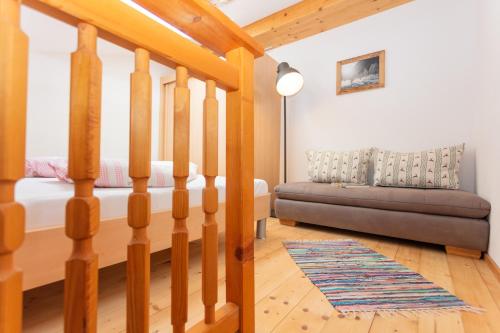 a living room with a bed and a couch at Frühstückspension Müllergut in Sankt Martin bei Lofer