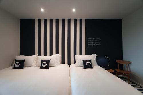 Ein Bett oder Betten in einem Zimmer der Unterkunft Blu Monkey Hub and Hotel Chanthaburi