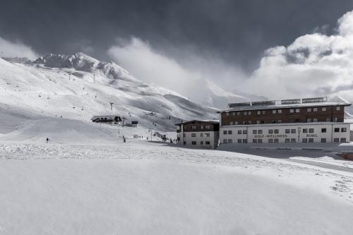 a building on top of a snow covered mountain at SKI - GOLF - WELLNESS Hotel Riml in Hochgurgl