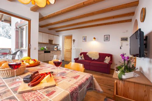 a kitchen and living room with a table and a couch at Binterhof in Castelrotto