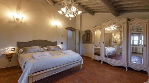 a bedroom with a bed and a large mirror at La Torre di Testa Lepre in Greve in Chianti
