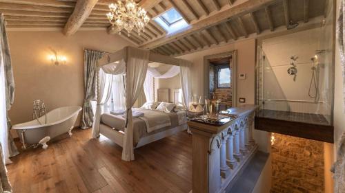 a bedroom with a bed and a bath tub and a tub at La Torre di Testa Lepre in Greve in Chianti