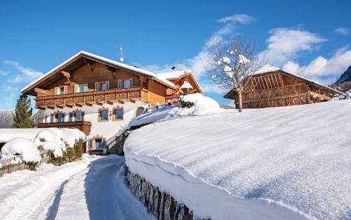a house covered in snow in front at Binterhof in Castelrotto