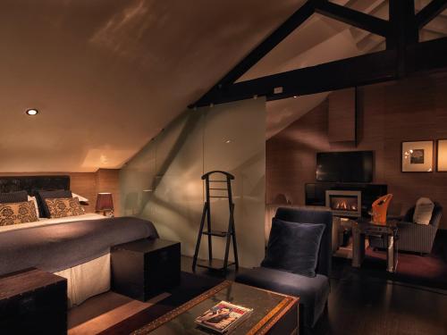 a bedroom with a bed and a ladder and a chair at Malmaison Belfast in Belfast