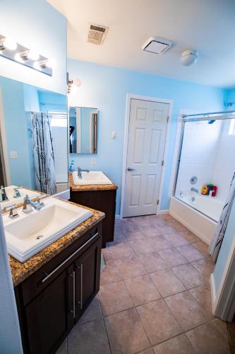 a bathroom with a large sink and a shower at Luxury 1900 SQ FT House Huge 46 FT Pool & Hot SPA in Las Vegas