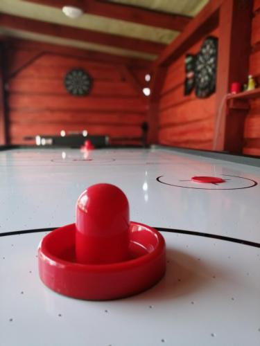a red object sitting on top of a table at Dom całoroczny Wczasy jak Marzenie in Ruciane-Nida