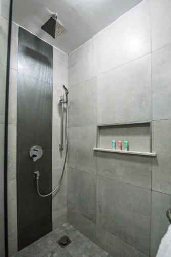 a shower with a glass door in a bathroom at Glam Hotel Nairobi - Near Westgate Mall, Westlands in Nairobi