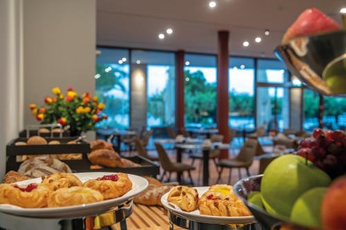 a table with three plates of pastries on it at Hotel Lago Maggiore - Welcome! in Locarno
