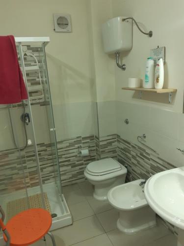 a bathroom with a shower and a toilet and a sink at B&B La Colonna in Crotone