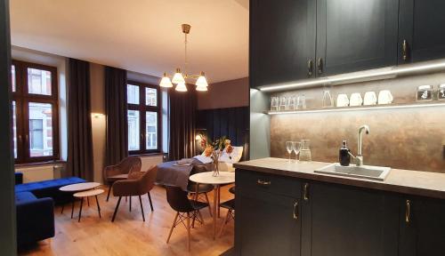 a kitchen and dining room with a table and chairs at DK Premium Warmińska Secesja in Olsztyn