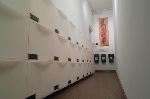 a hallway with a row of lockers in a room at Chic Capsule Otel in Singapore