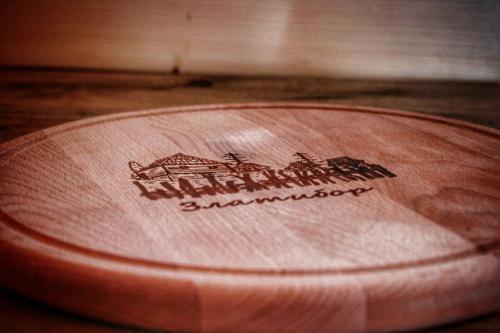 a close up of a wooden lid with a logo on it at Brvnara Zečević in Zlatibor