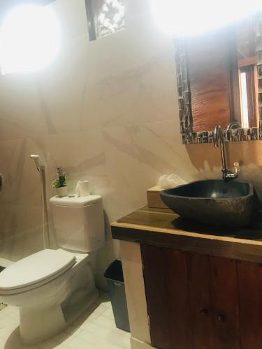 a bathroom with a toilet and a sink at Volcano Valley in Kintamani
