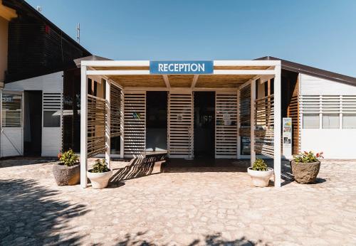 a building with a sign that reads repetition at Natural Village Resort in Porto Potenza Picena