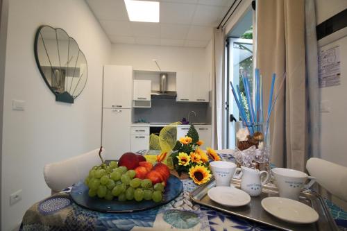 a table with a plate of fruit on top of it at Residence BluAdria in San Mauro a Mare
