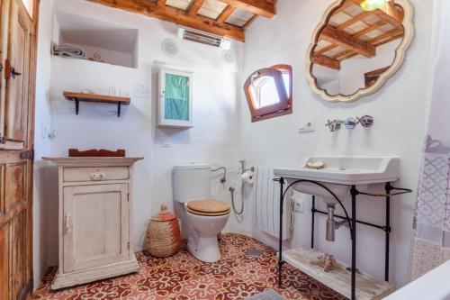 a bathroom with a sink toilet and a mirror at Ático Al Andalus in Tarifa
