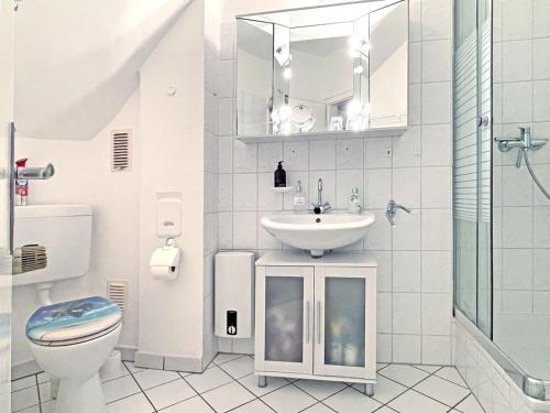 biała łazienka z umywalką i toaletą w obiekcie Ferienwohnung Köln-Poll w Kolonii