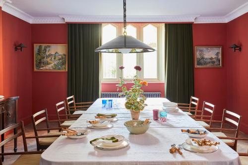 a dining room with red walls and a table with food at Oakley Court in Windsor